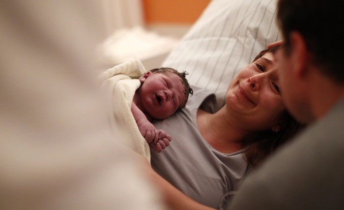Newborn Stefan rests with mother Heinrich in delivery room of Fuerstenfeldbruck hospital