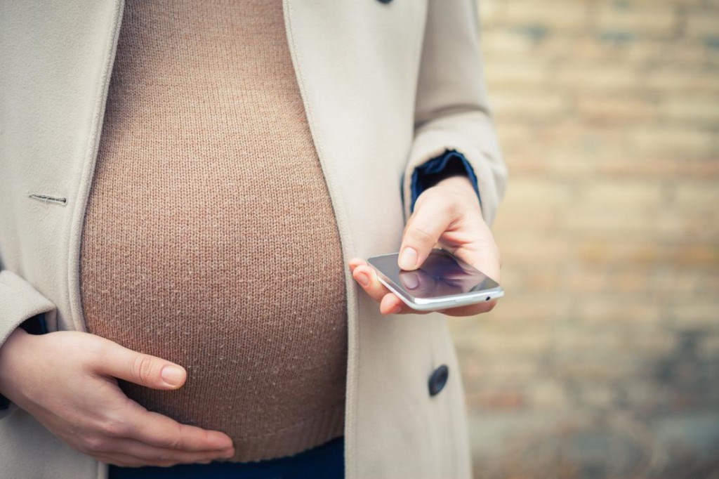 pregnant woman calling by mobile phone