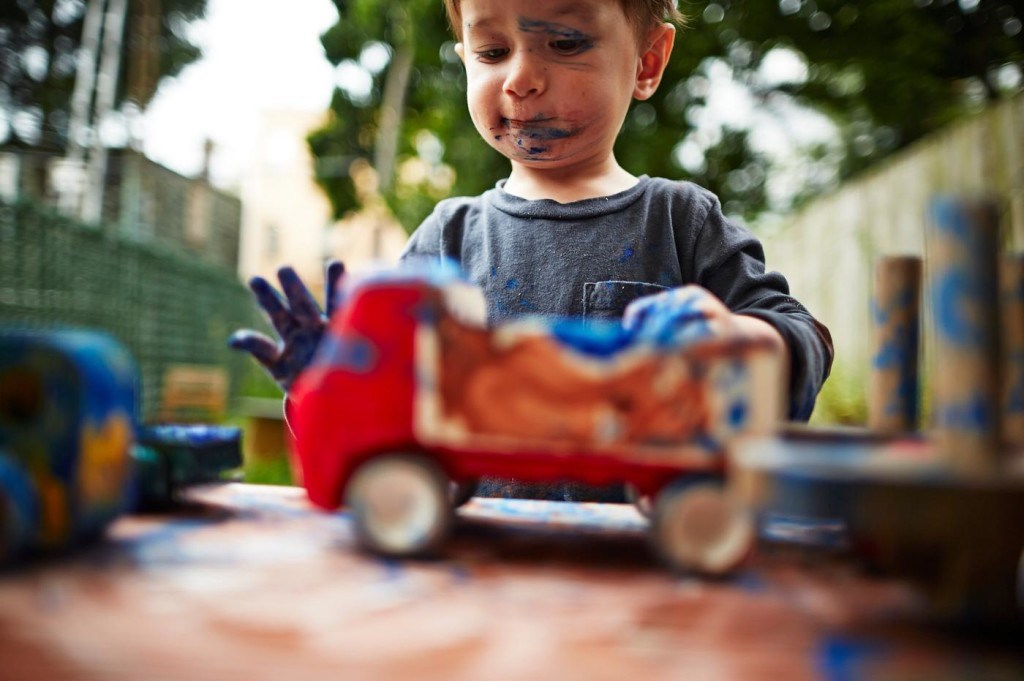 boy-playing-with-toy-trucks-and-watercolour