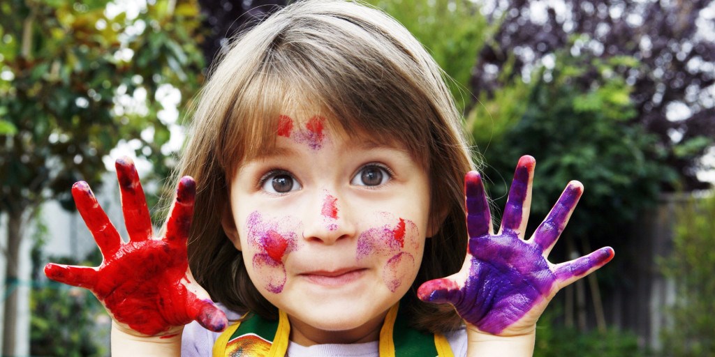 Young girl with painted hands and face